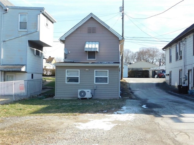 rear view of property with ac unit