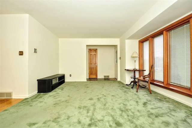 unfurnished living room featuring carpet flooring