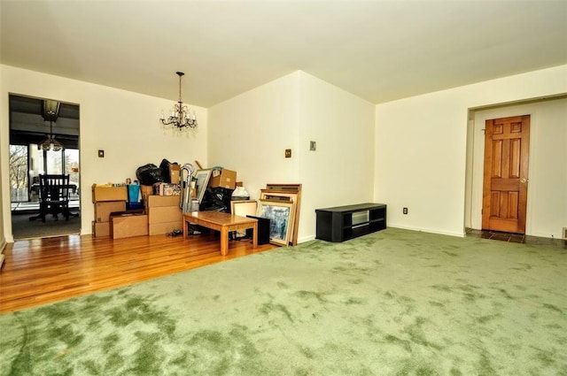 interior space featuring hardwood / wood-style floors, a baseboard heating unit, and an inviting chandelier