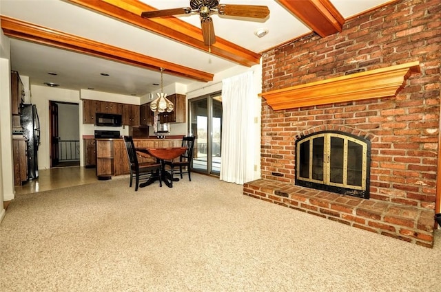 unfurnished living room with beam ceiling, ceiling fan, a fireplace, and carpet flooring