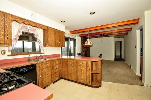 kitchen featuring decorative light fixtures, a healthy amount of sunlight, kitchen peninsula, and a brick fireplace