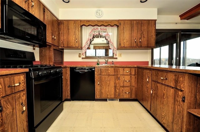 kitchen with sink and black appliances