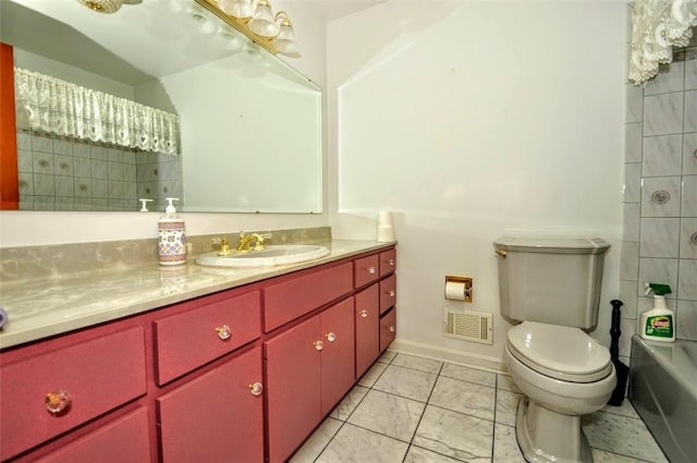 bathroom featuring vanity, toilet, and a tub