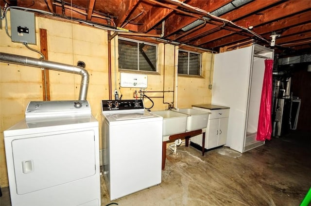 laundry area with independent washer and dryer and sink