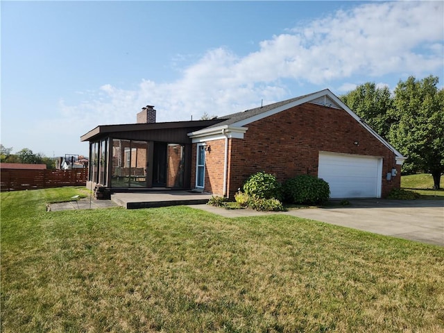 exterior space featuring a garage and a front lawn