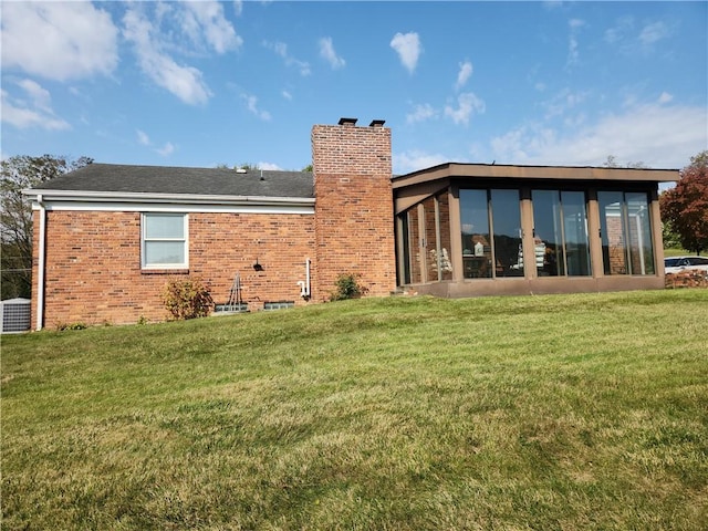 rear view of property with a yard