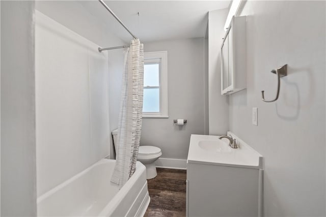 full bathroom with shower / bathtub combination with curtain, hardwood / wood-style floors, vanity, and toilet