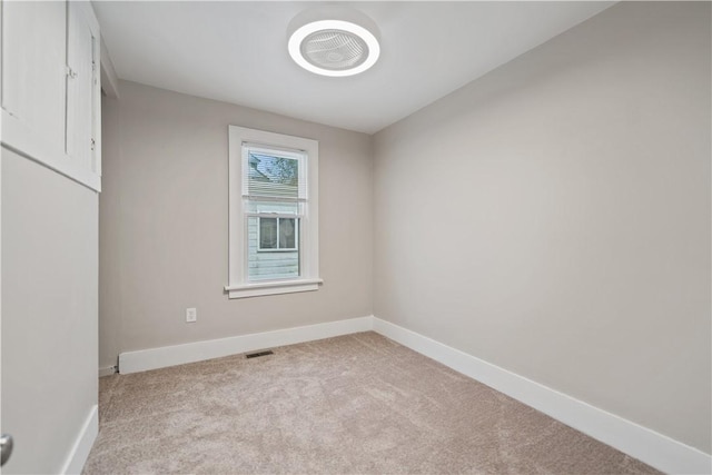 unfurnished room with light carpet