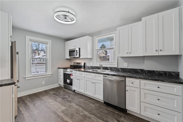 kitchen featuring white cabinetry, sink, dark wood-type flooring, and appliances with stainless steel finishes