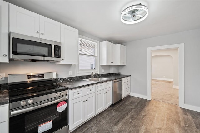 kitchen with sink, white cabinets, stainless steel appliances, and dark hardwood / wood-style floors