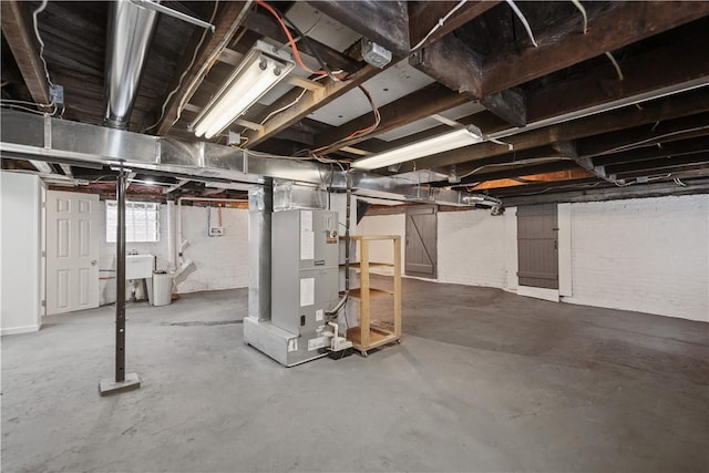 basement with sink and heating unit