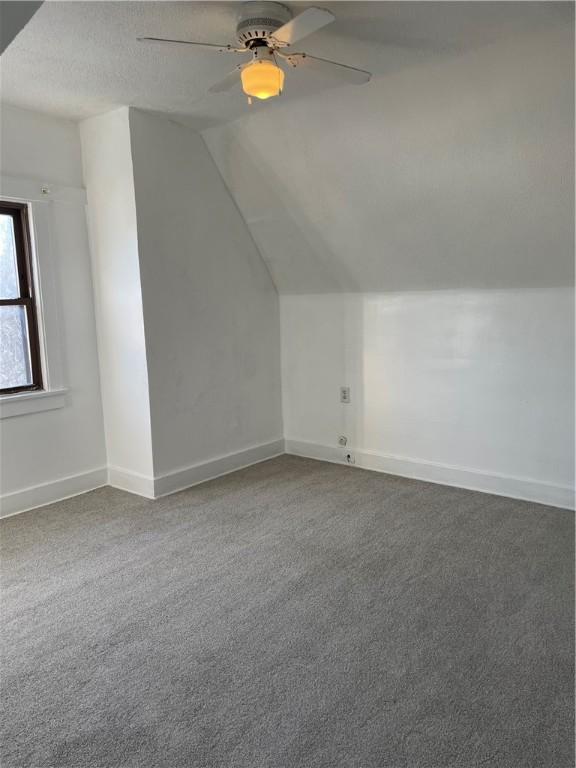 bonus room with carpet flooring, ceiling fan, a textured ceiling, and lofted ceiling