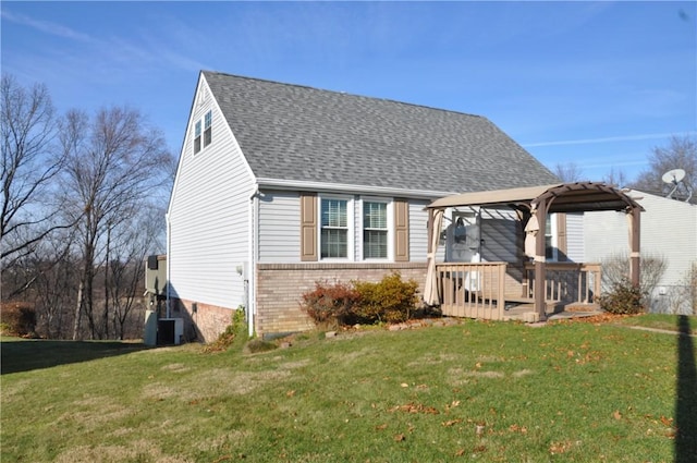 view of front of property with a gazebo, a deck, and a front lawn