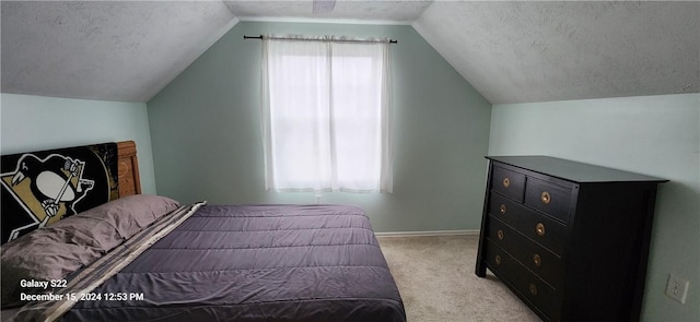 carpeted bedroom featuring a textured ceiling and vaulted ceiling