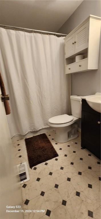 bathroom featuring vanity and toilet