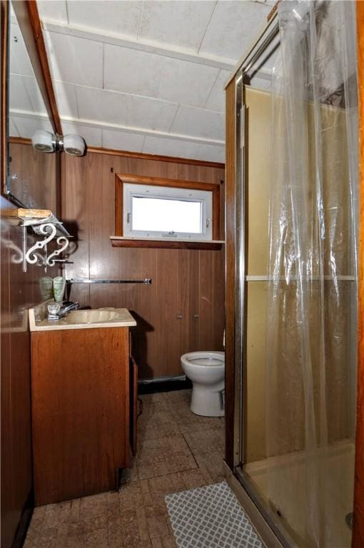 bathroom featuring vanity, a shower with curtain, toilet, and wooden walls