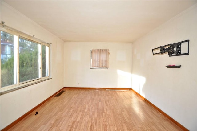 spare room with light hardwood / wood-style floors