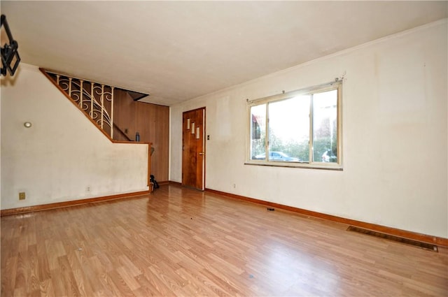 interior space with light hardwood / wood-style flooring and ornamental molding