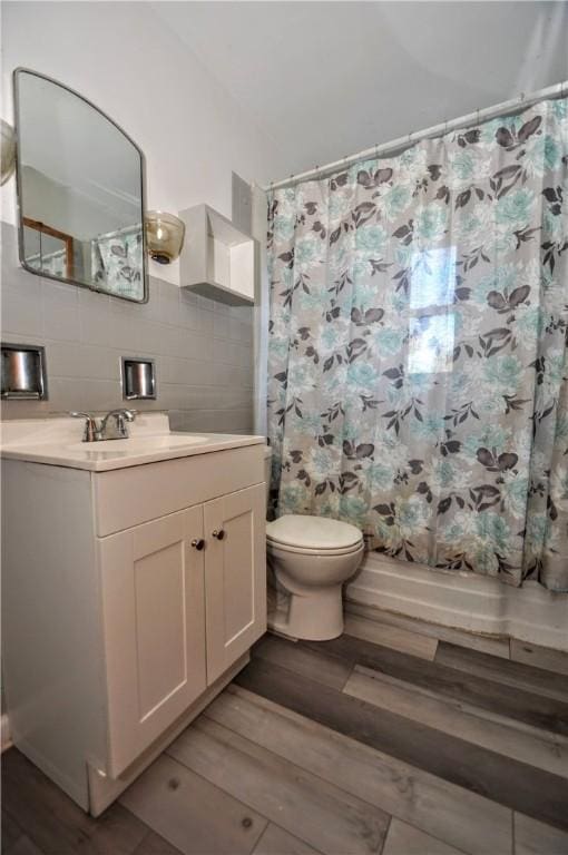 bathroom with vanity, hardwood / wood-style floors, backsplash, and toilet