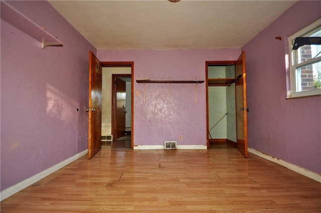 unfurnished bedroom featuring light wood-type flooring