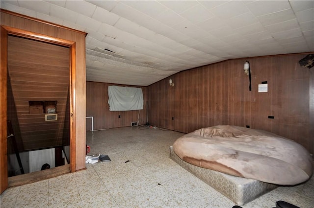 additional living space with vaulted ceiling and wooden walls