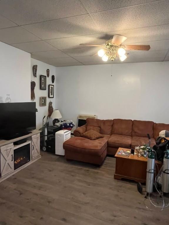 living room with hardwood / wood-style flooring, ceiling fan, and a fireplace