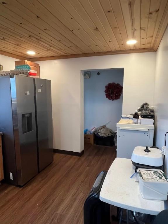 kitchen featuring stainless steel fridge, crown molding, wood ceiling, and dark wood-type flooring