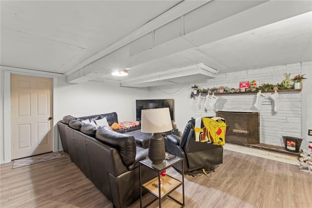 living room featuring wood-type flooring and a fireplace