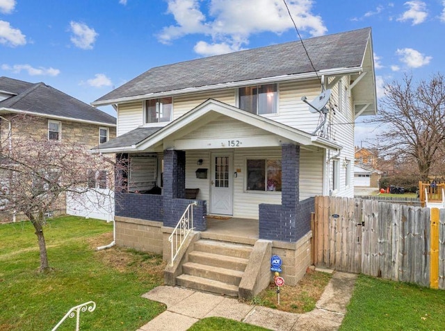 view of front facade with a porch and a front lawn