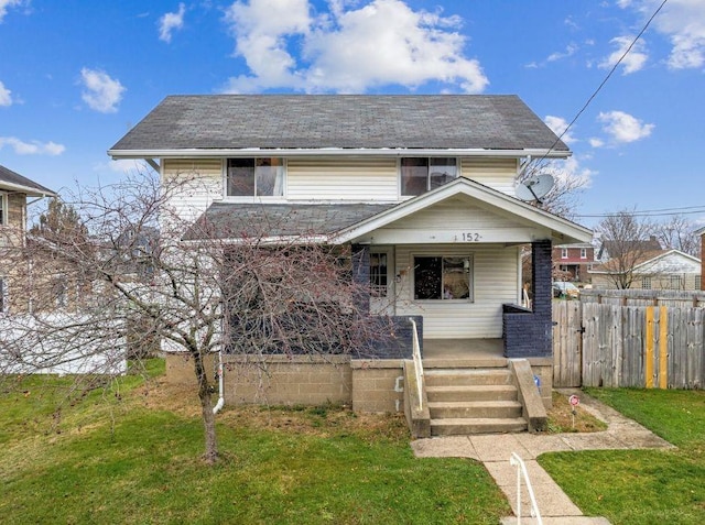 view of property with covered porch and a front yard