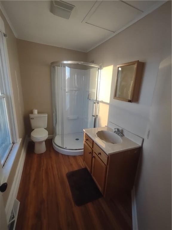 bathroom with toilet, vanity, an enclosed shower, and hardwood / wood-style flooring