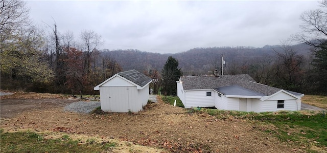 view of home's exterior with a storage unit