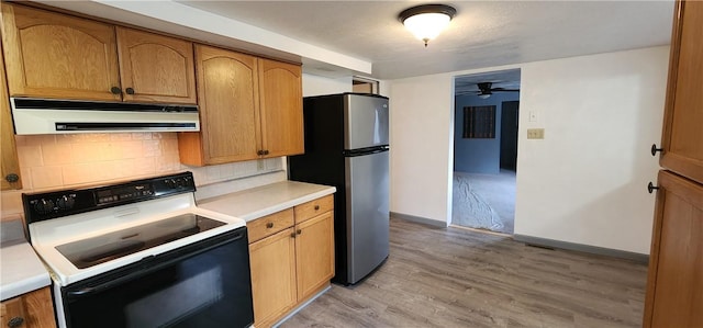 kitchen with stainless steel refrigerator, ceiling fan, backsplash, electric stove, and light wood-type flooring