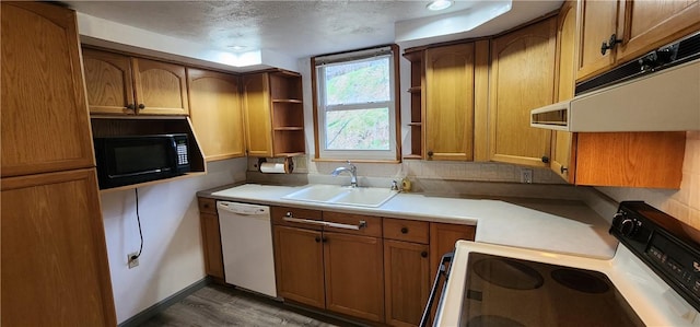 kitchen with sink, dark hardwood / wood-style floors, a textured ceiling, white appliances, and exhaust hood