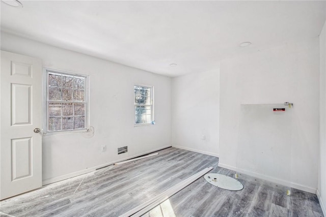 empty room with wood-type flooring