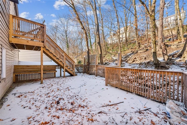 yard layered in snow with a deck