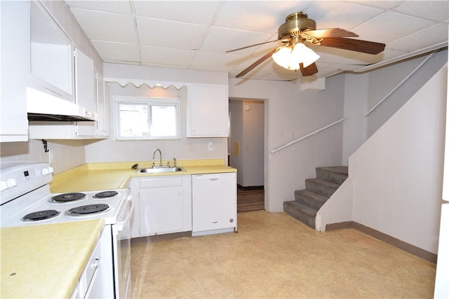 kitchen with a drop ceiling, white appliances, white cabinets, sink, and range hood