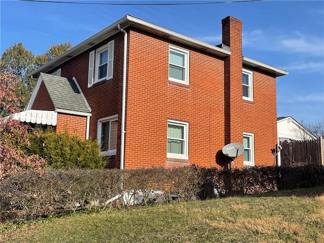 view of home's exterior with a yard