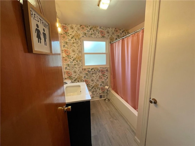 bathroom featuring hardwood / wood-style flooring, vanity, and shower / tub combo with curtain