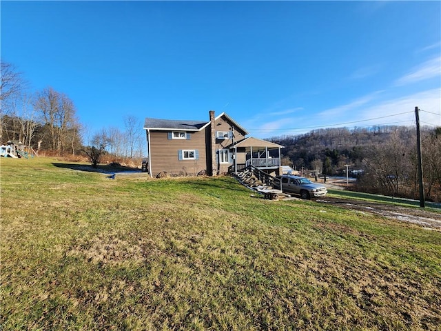 rear view of house featuring a lawn