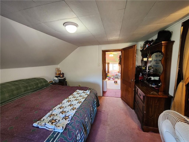 carpeted bedroom with lofted ceiling