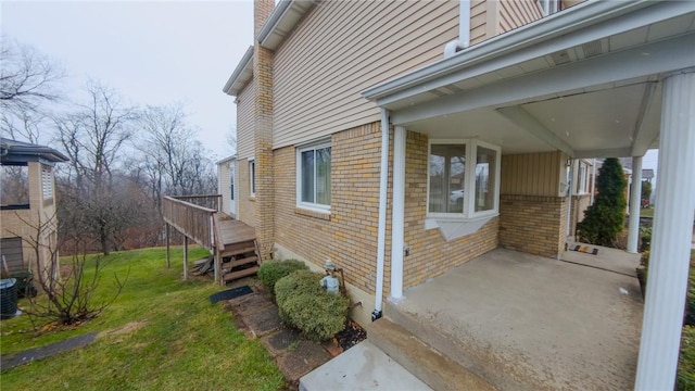 view of property exterior with a lawn and a deck