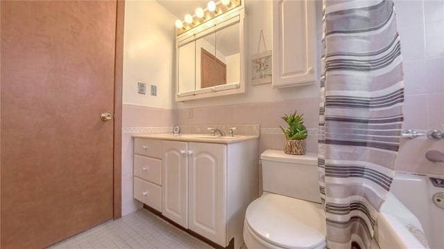 full bathroom featuring tile patterned floors, vanity, tile walls, and toilet