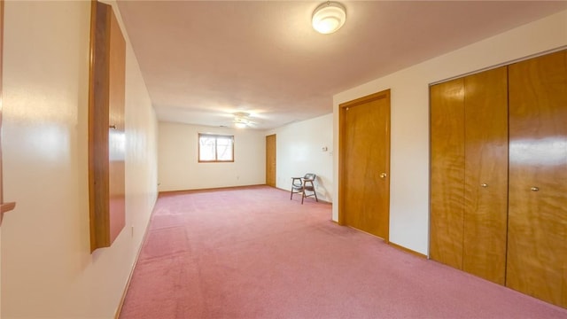 interior space with ceiling fan and carpet floors