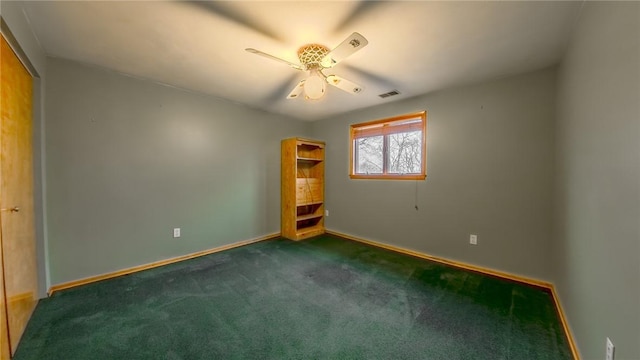 unfurnished bedroom featuring dark colored carpet and ceiling fan