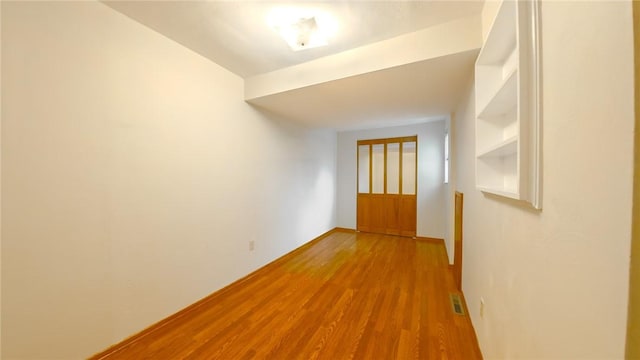 corridor with wood-type flooring