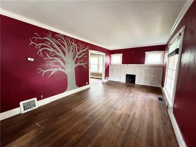 unfurnished living room featuring wood-type flooring, ornamental molding, and a brick fireplace