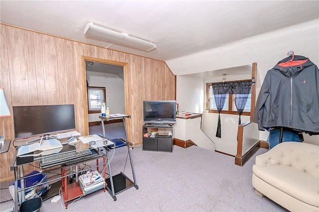 carpeted home office featuring wooden walls