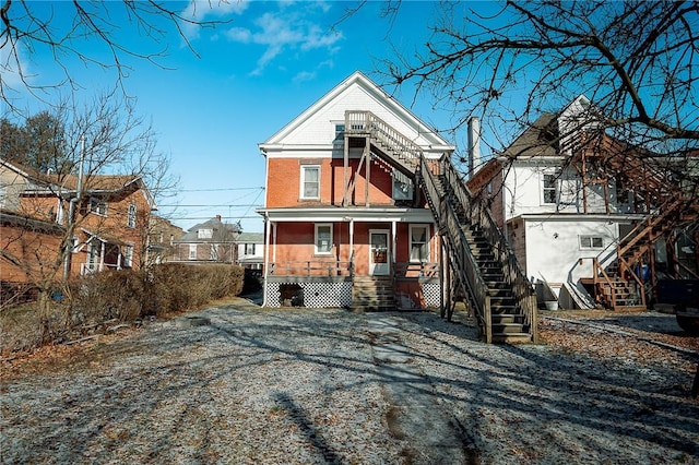 rear view of house with covered porch