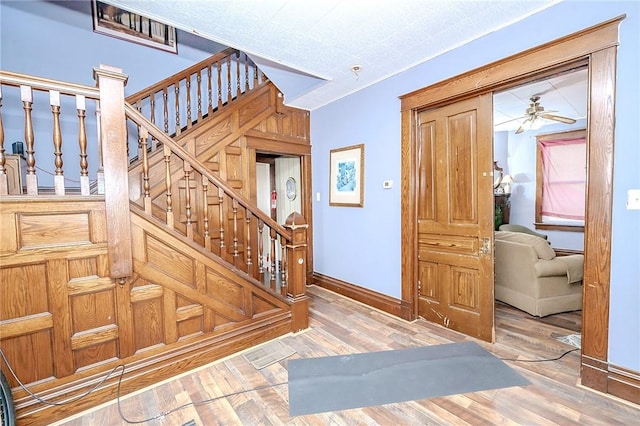 entrance foyer with wood-type flooring and ceiling fan